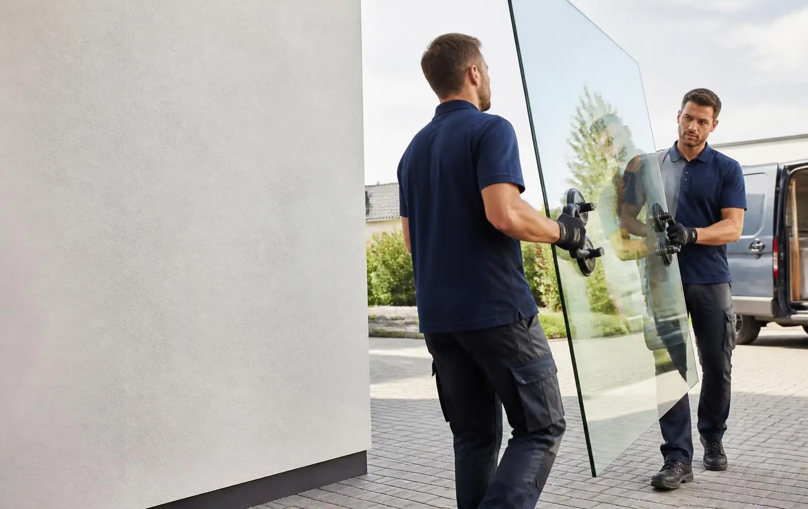 ProLine glaziers carrying a large pane of glass at a Dallas home